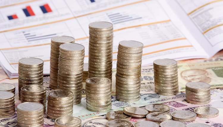 Stack of coins with financial report as the backdrop