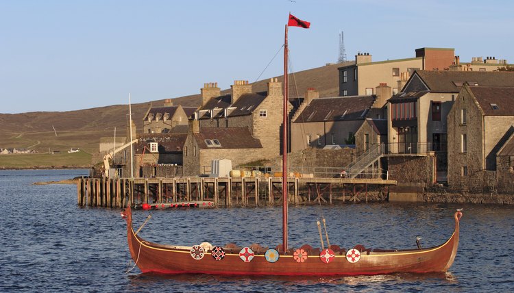 A viking boat in a small harbour.