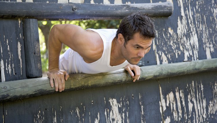 Man climbing through obstacle course