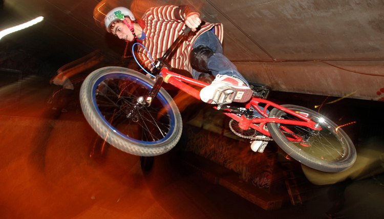 Low angle view of a teenage boy performing stunts on a bicycle