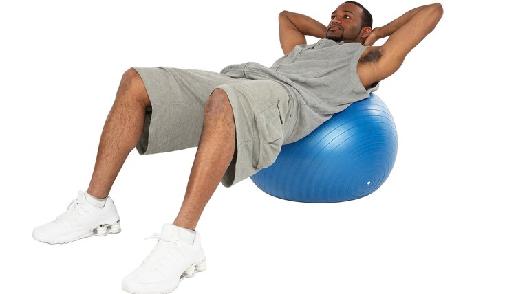 Man doing crunches on exercise ball