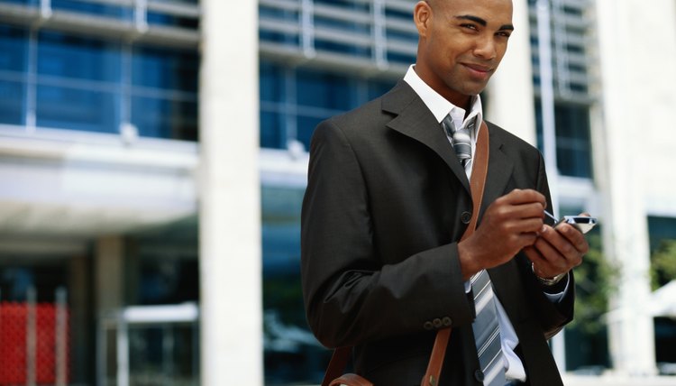 Business man wearing leather shoulder bag.