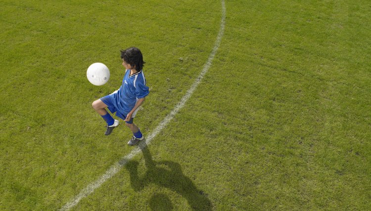 Boy (8-10) footballer practicing skills, elevated view