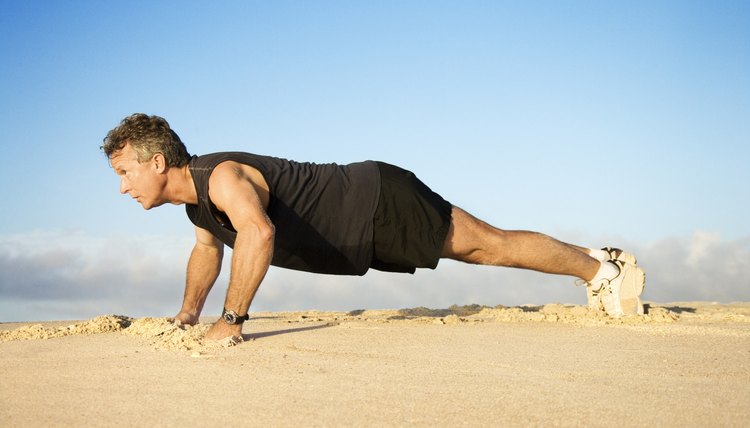 Man doing pushups in sand