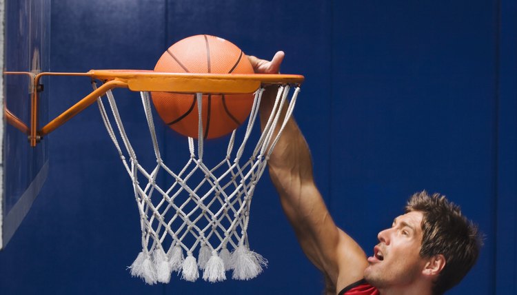 Man dunking basketball