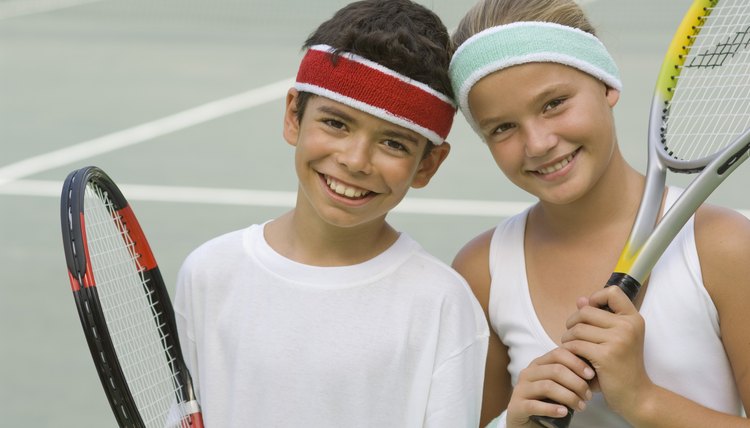 Portrait of children with tennis rackets