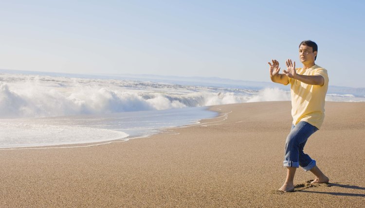 Man doing tai chi on beach