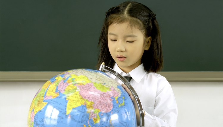 Young student looking at a globe