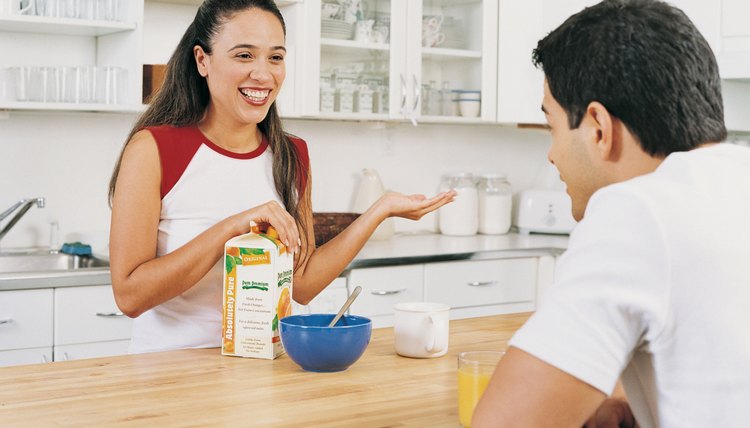 Young Adult Couple in a Kitchen Having Breakfast