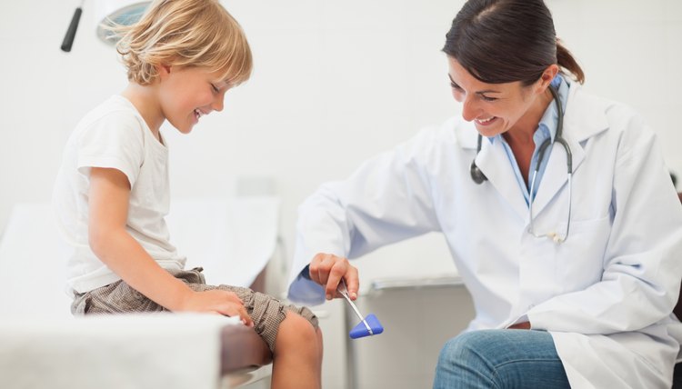 Doctor testing reaction of a child leg