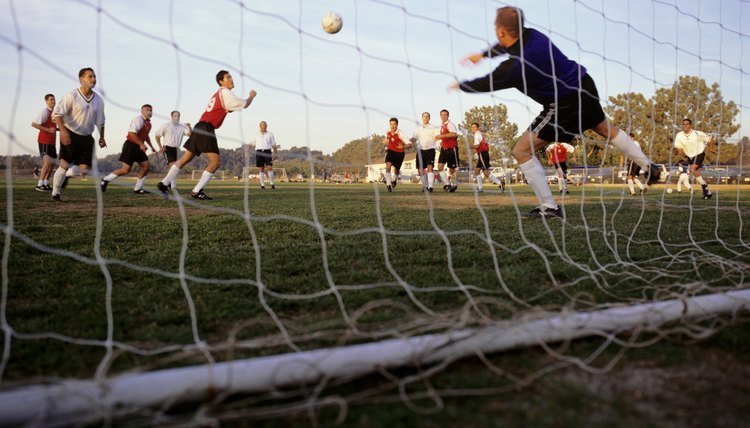 Goalkeeper making dash towards ball, low angle view