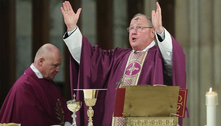 Cardinal Timothy Dolan in purple robe on Ash Wednesday, the first day of Lent.