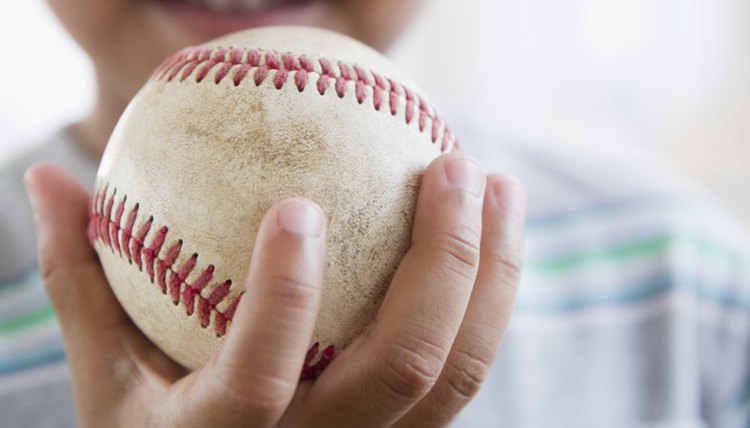 African American boy holding baseball