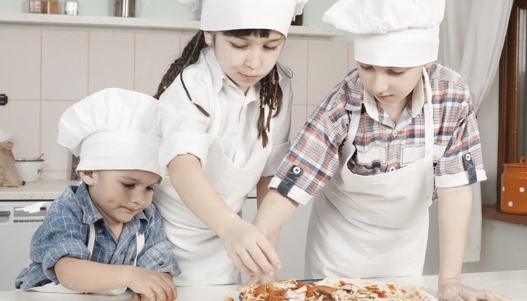 Young children making a pizza
