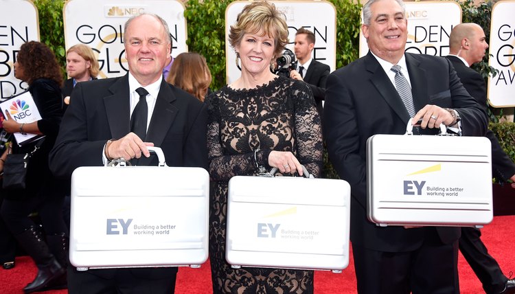 Ernst & Young representatives bring in the list of winners to the Golden Globes awards show.