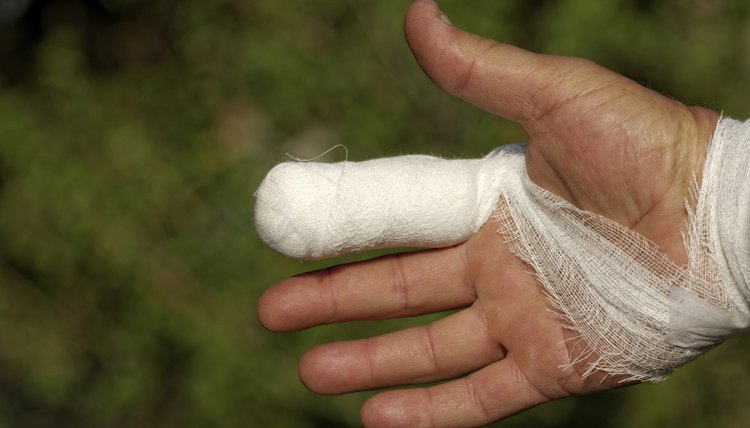 White medicine bandage on human injury hand finger