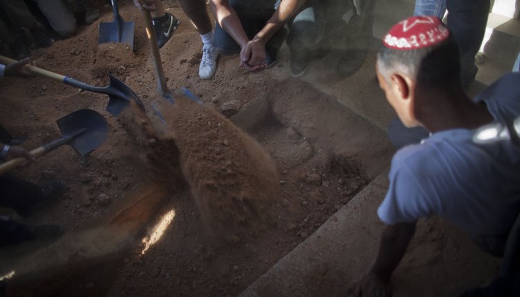 Relatives shovel dirt at funeral in Israel