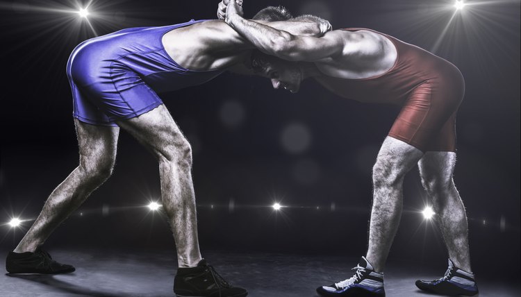 Two wrestlers in stance on stage