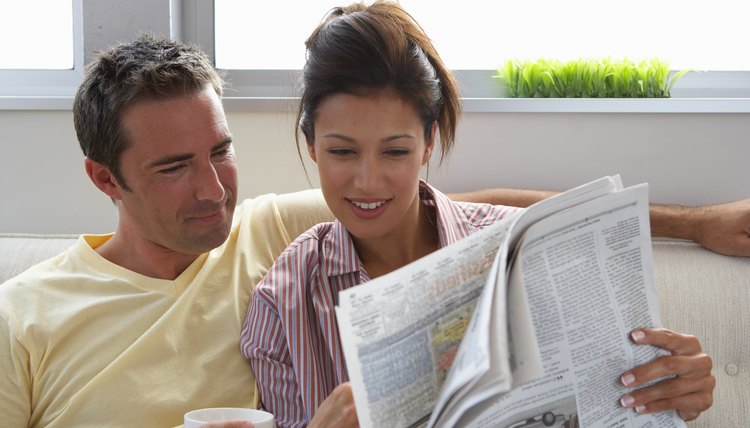 Couple reading the newspaper.