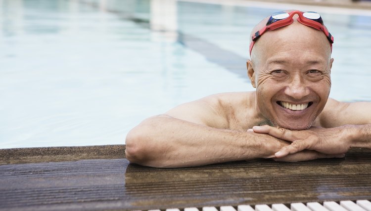 Smiling senior man swimmer wearing goggles