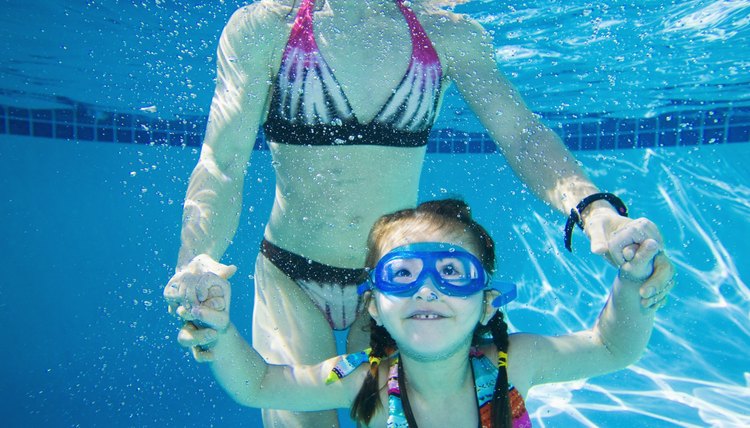 Underwater shot of Asian mother and daughter