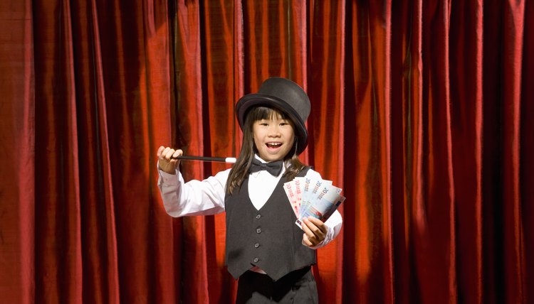 Young girl performing magic trick.
