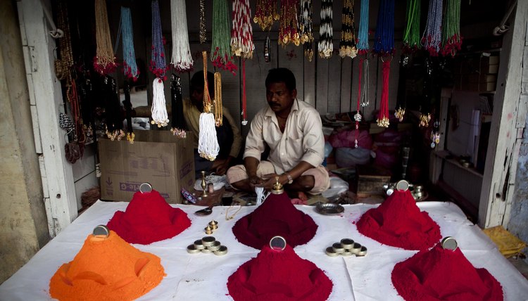 A man in India sells colored powder for Hindu revelers during Holi.