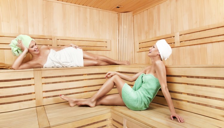 Two women relax inside sauna