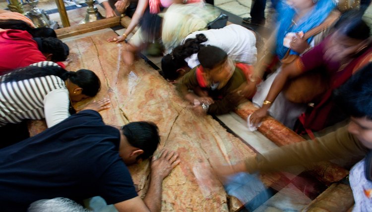 Pilgrims kiss the stone slab where the body of Jesus was anointed before burial at the Church of the Holy Sepulchre in Jersualem.