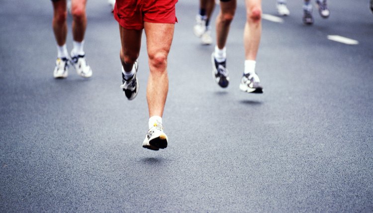 Marathon runners on road, low section 