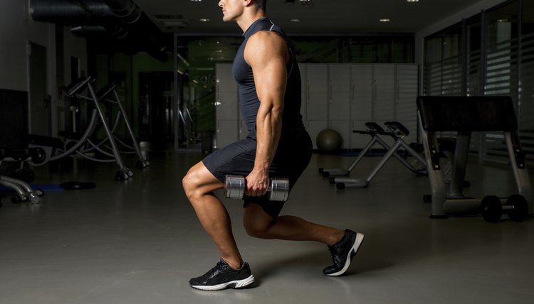 Young Man Exercising Lunges with Weights