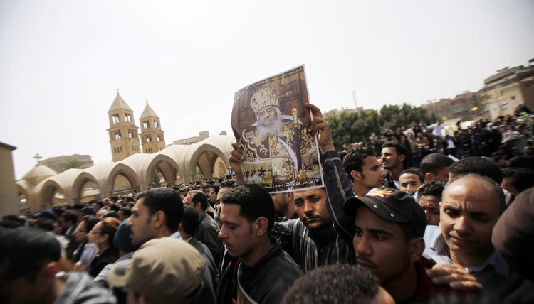 Copts mourn the death of their pope outside a Coptic Cathedral in Cairo, Egypt.