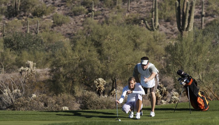 Helping a golfer read a green may be a part of a caddie's role.