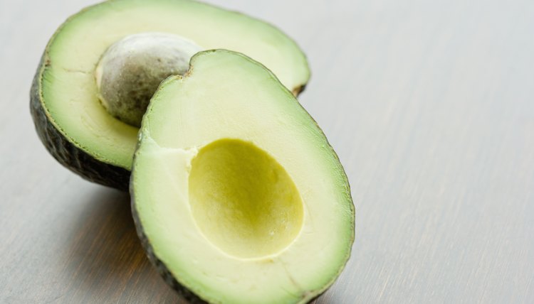 Halved avocado on tabletop, close up