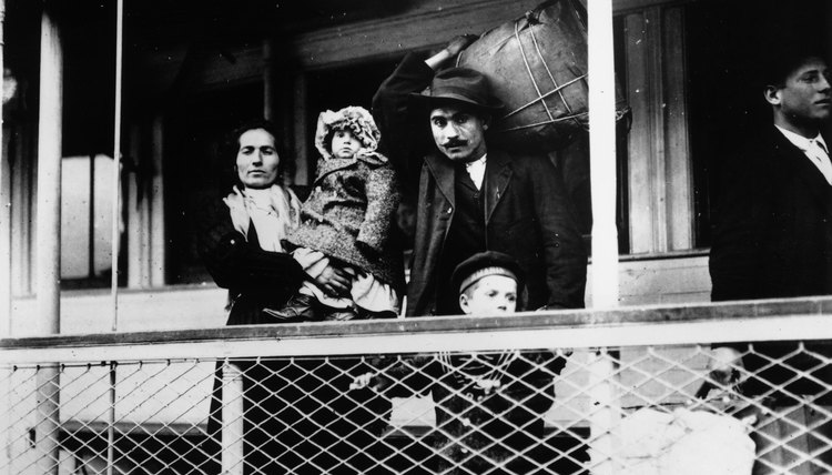 Early 20th century Italian immigrant family on ferry docking at Ellis Island, New York