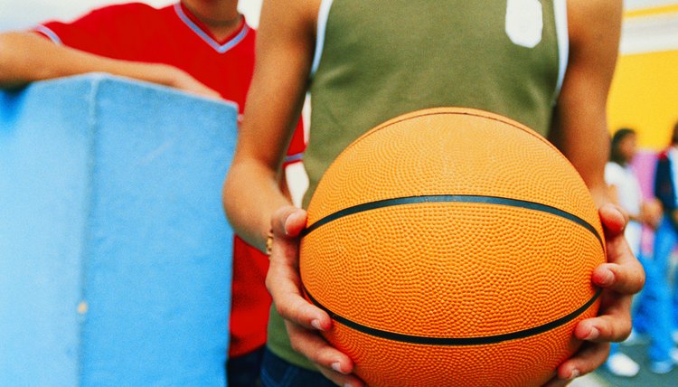 close-up of a teenage boy's hands holding a basketball