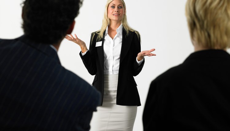 Businesswoman giving presentation holding out hands