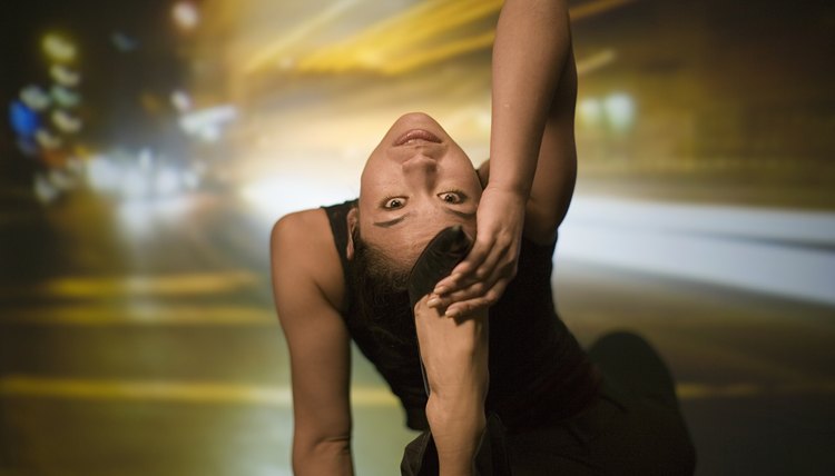 Young woman stretching, street scene projected in background