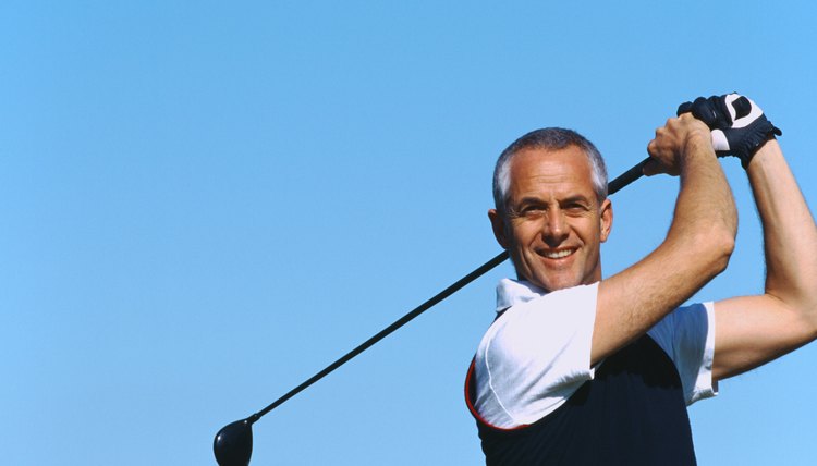 Portrait of an mature man smiling after a shot of golf