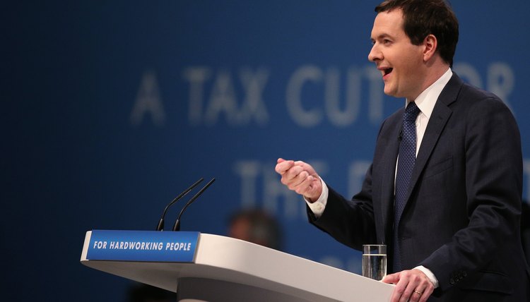 A politician speaking at a podium during a conference.