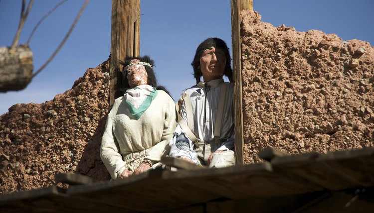 Indian dolls on top of old mining town building in California
