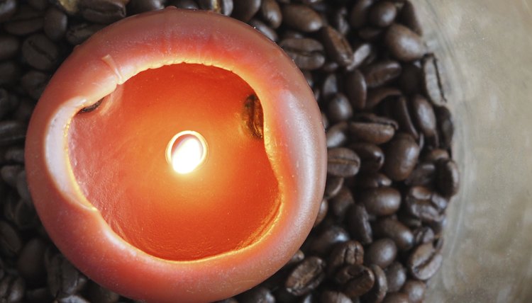 A candle burning in coffee beans.
