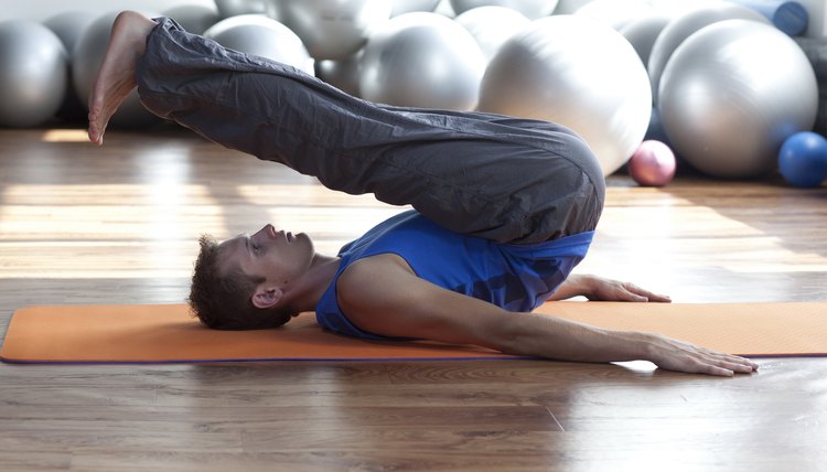 fusion of mind and body - man practicing pilates