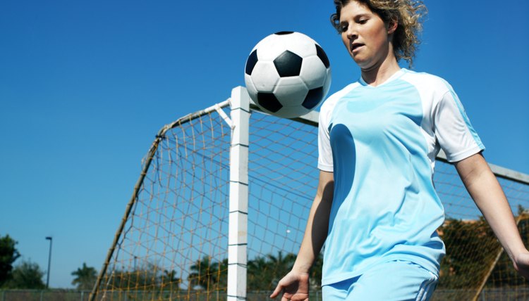 a young girl playing football