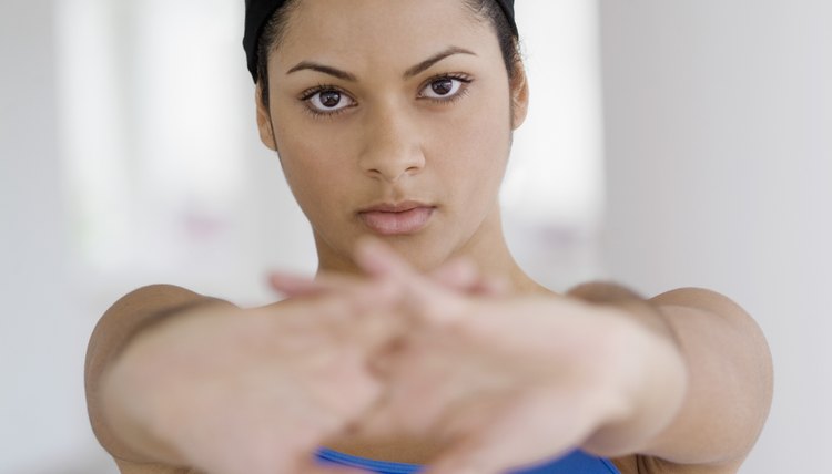 Teenage girl stretching with hands together, selective focus, close-up