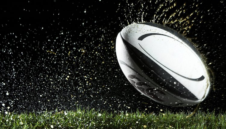 Rugby ball in motion over grass