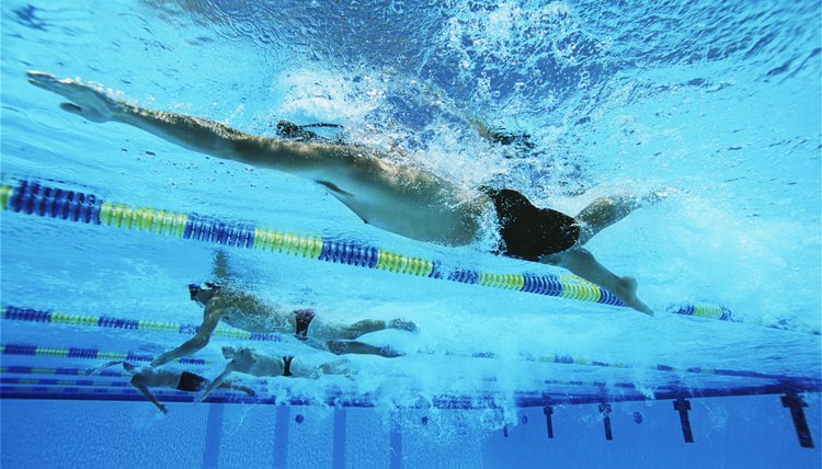 Male swimmers racing in pool, underwater view