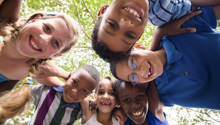 Smiling young children standing in a circle.