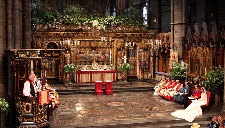 The Lord Bishop of London reading from the pulpit in Westminster Abbey.