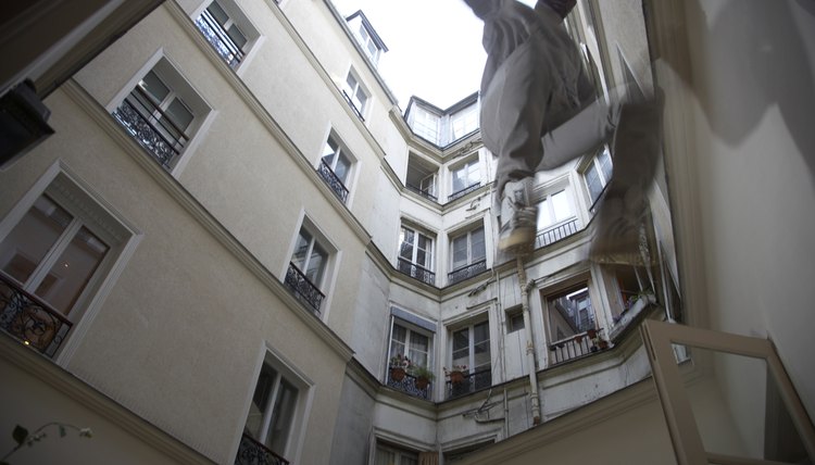 Man jumping off wall, low angle view